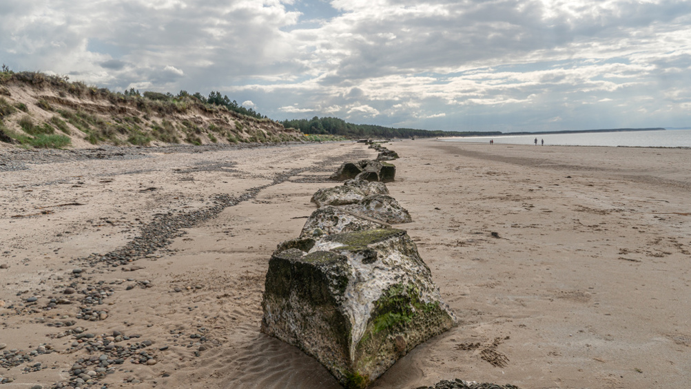 View of a beach with large concrete structures on it