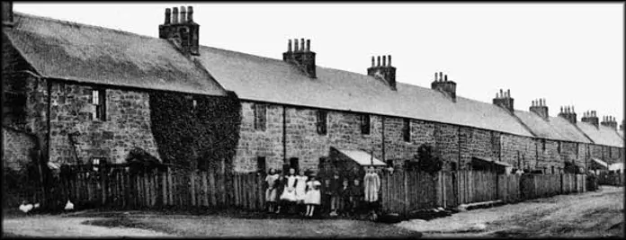 Black and white photo of row of small terraced houses