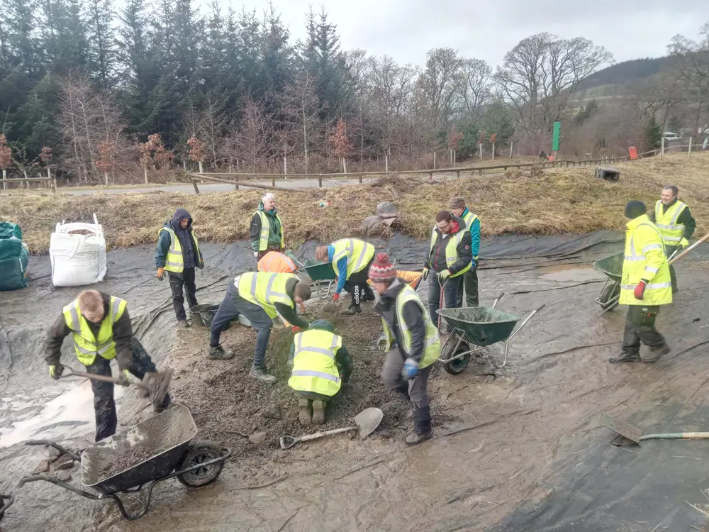 Volunteers at work on the pond